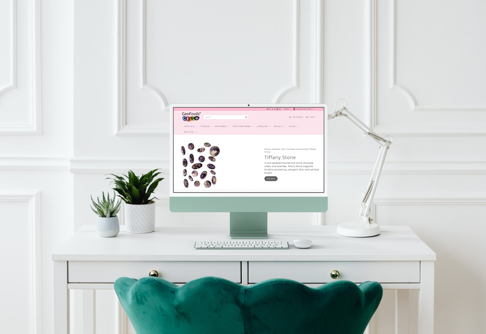 Computer monitor on a desk with a white wall and decorative elements